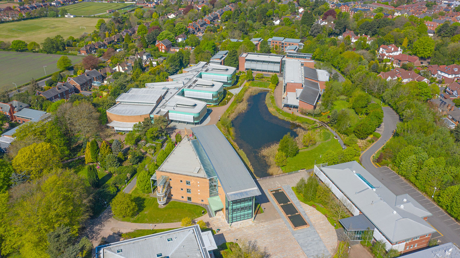 Aerial view of campus showcasing the CSSC, FHSCM and FoE buildings with the lake in the centre