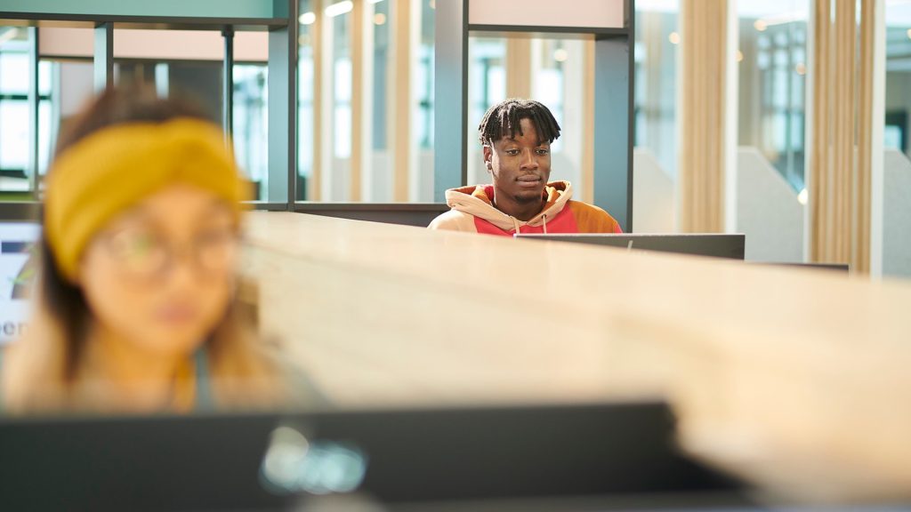 Student sat at a computer in the Catalyst building