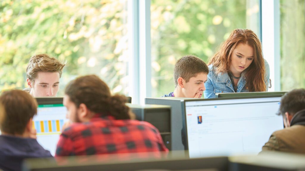 Data science students working at the computers.