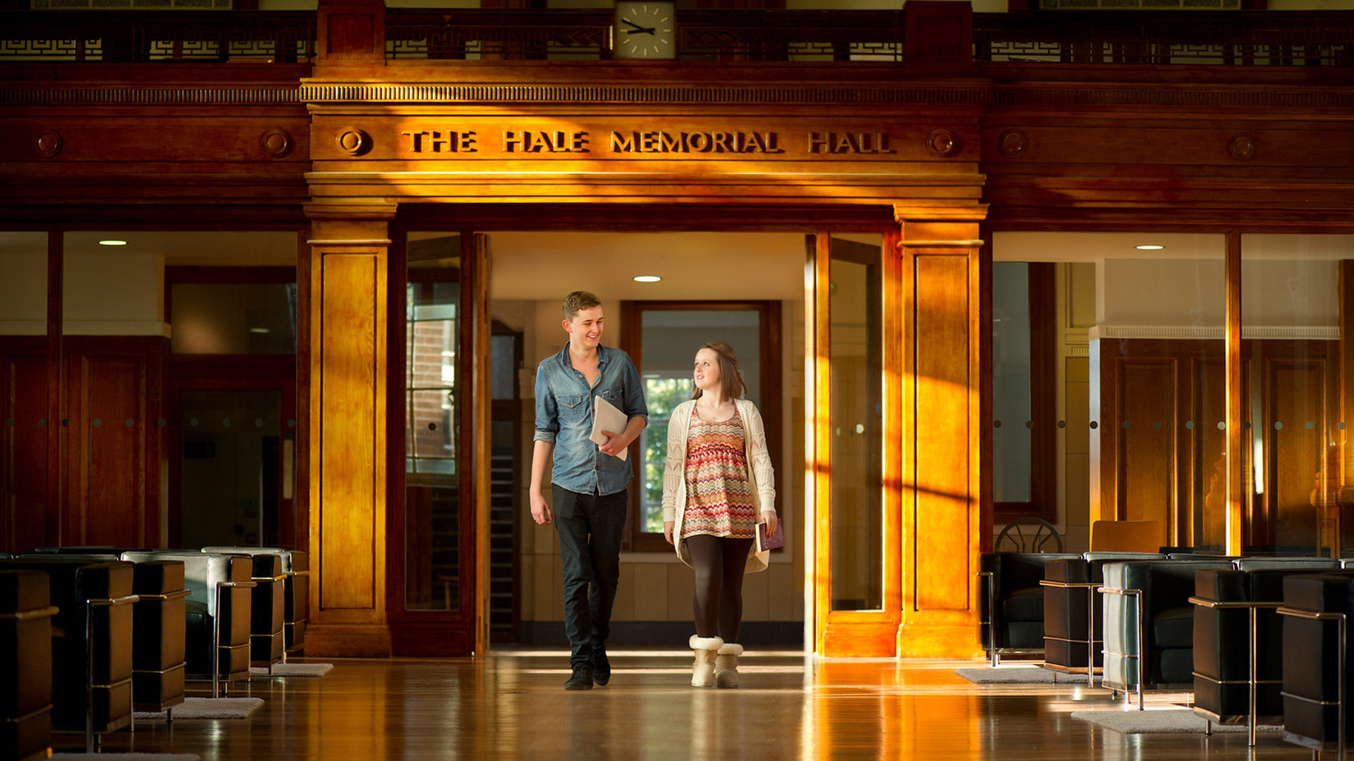 Two students walk together through hale hall