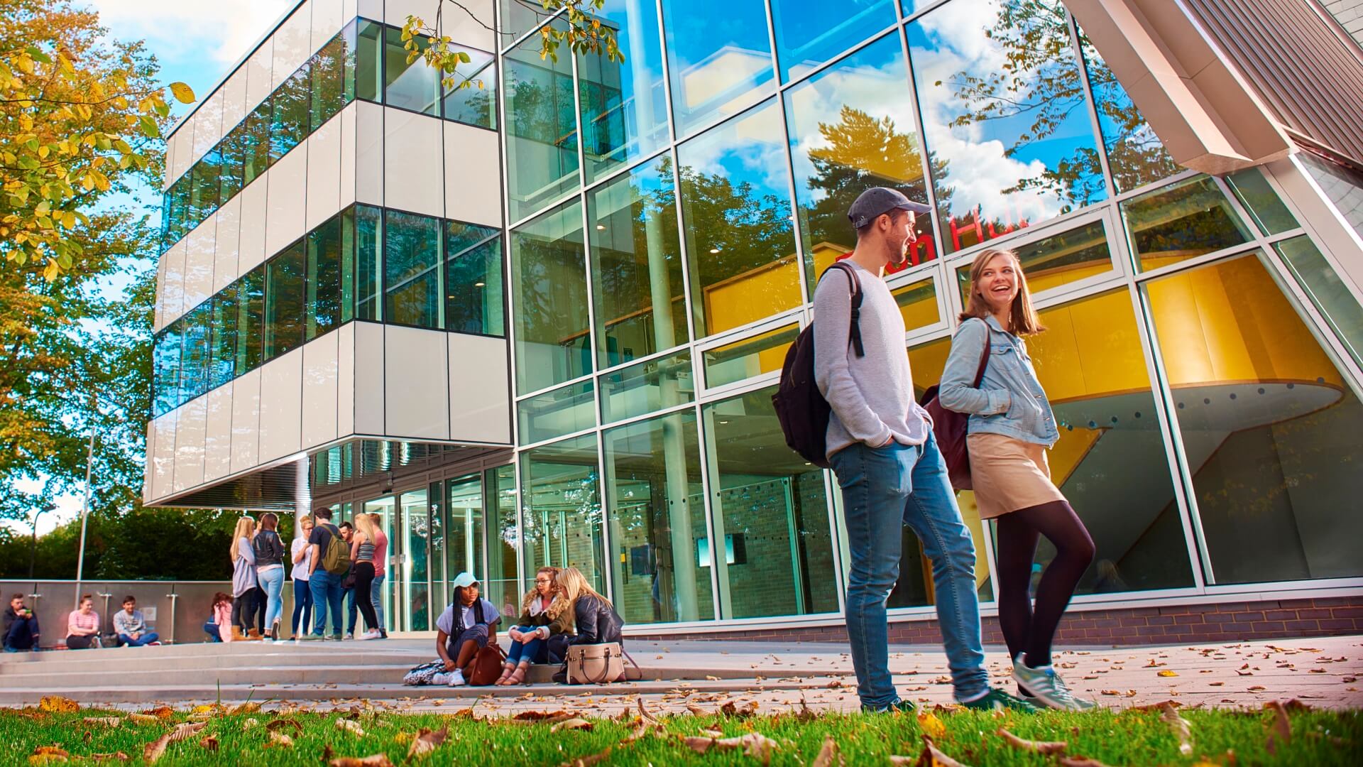 Two students walk outside the front of the Tech Hub.