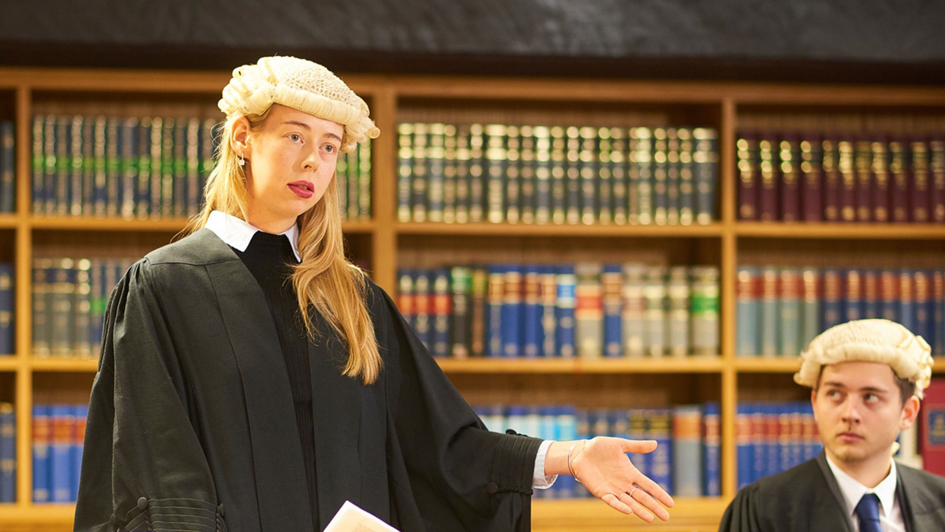 A student wearing robes and wig in the mock courtoom