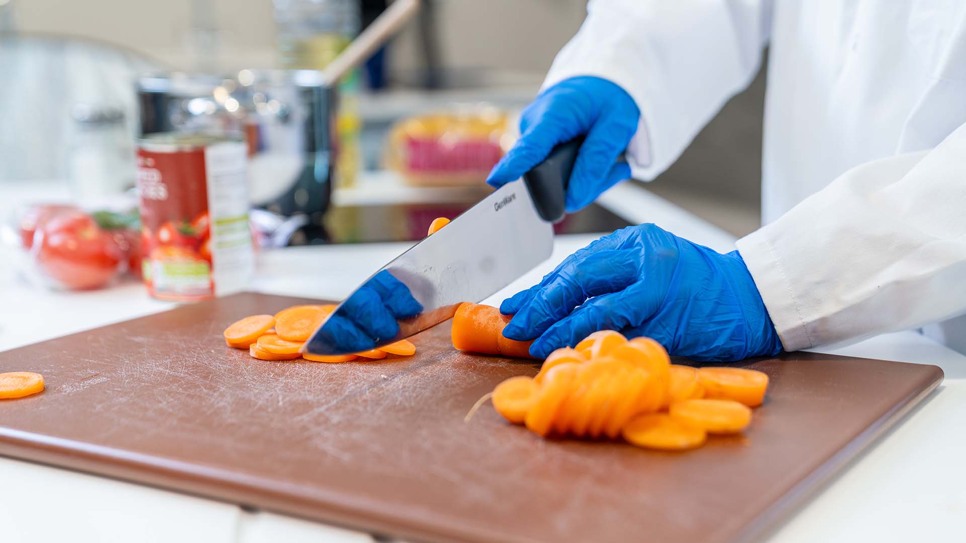 Close up shot of a nutrition student cutting a carrot with a knife