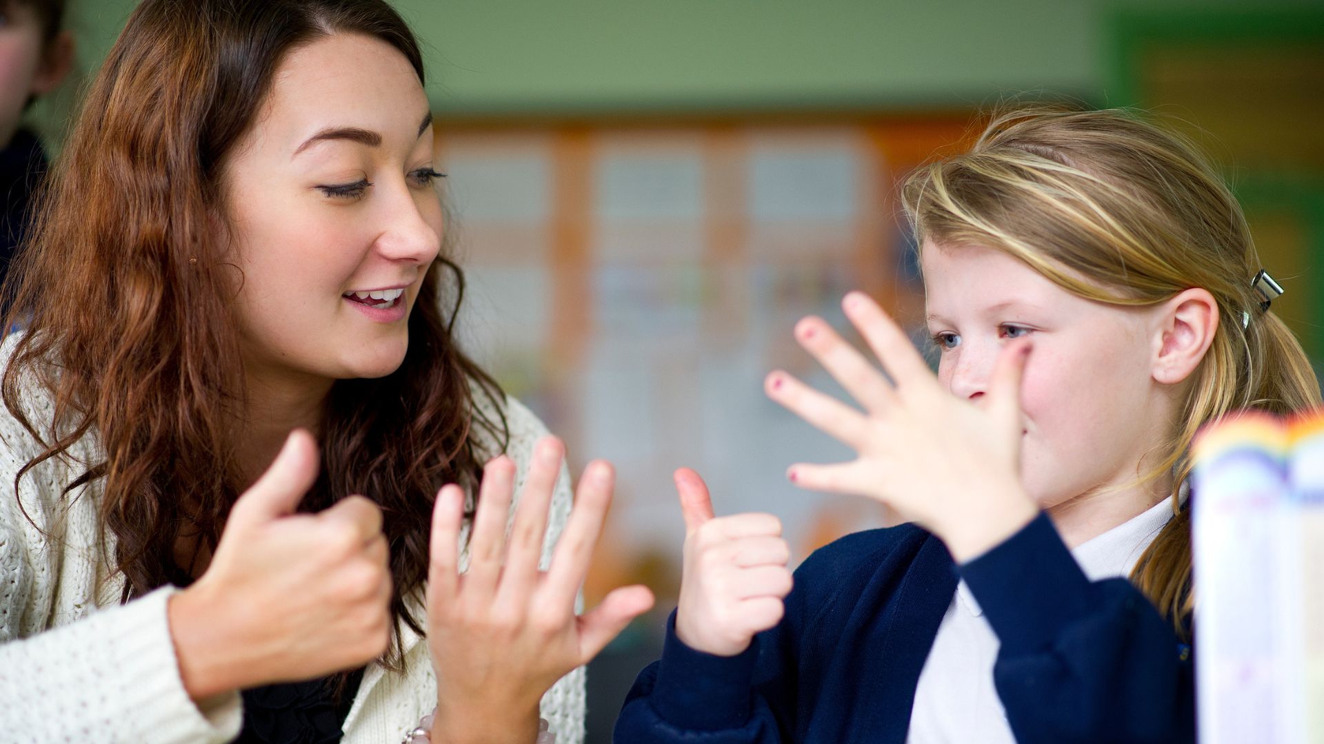 teacher and pupil counting using their fingers