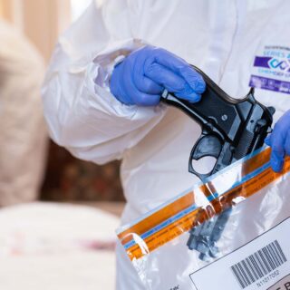 Policing student placing a gun into an evidence bag