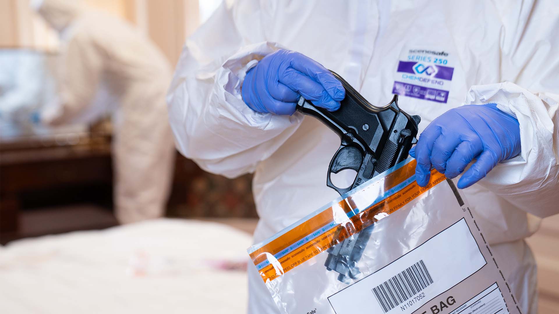 Policing student placing a gun into an evidence bag