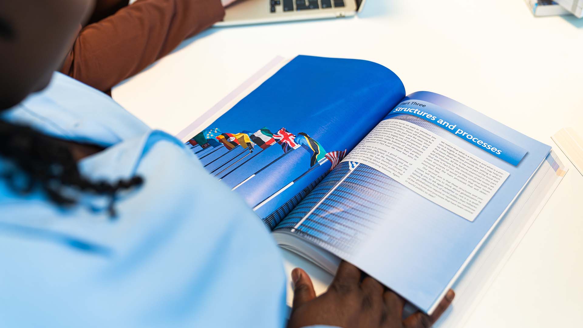 Close up shot of a student reading a politics textbook