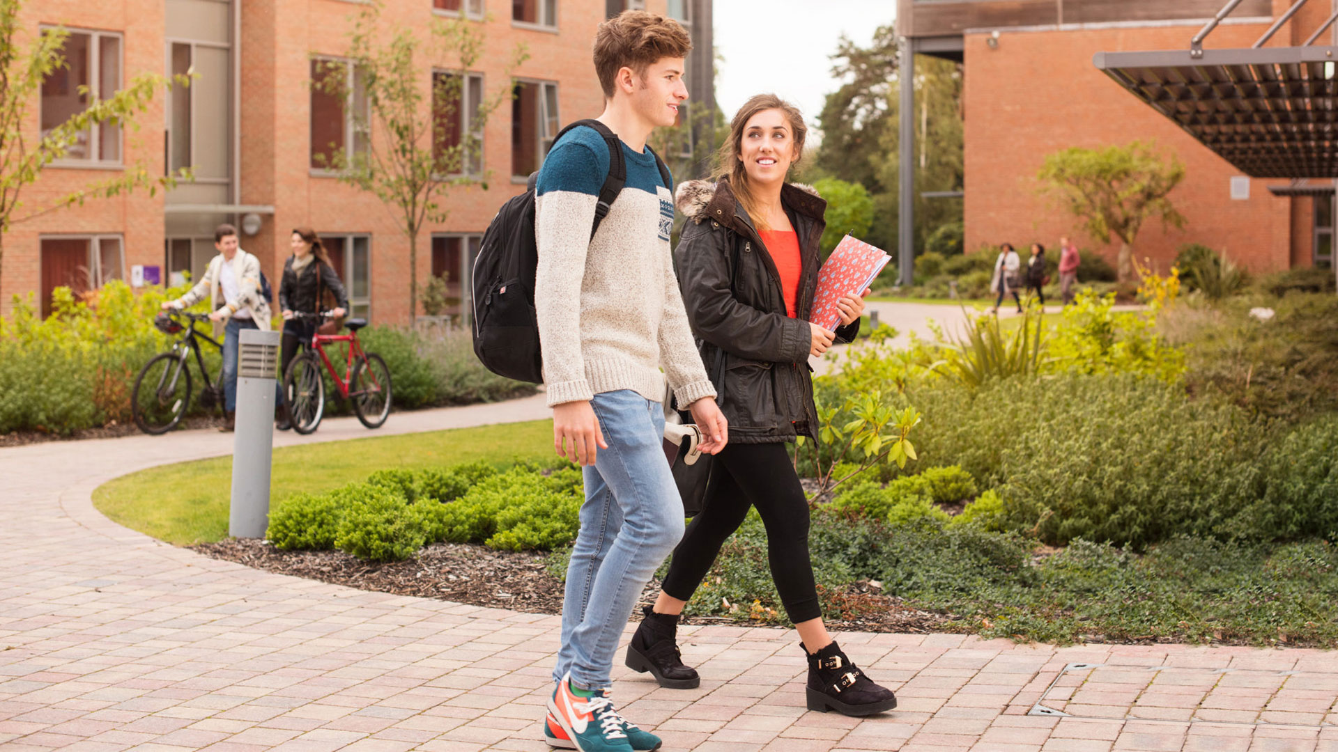 Two students walking through campus together
