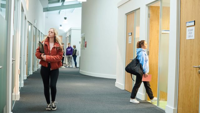 Students walking in the corridors in the Law and Psychology building.