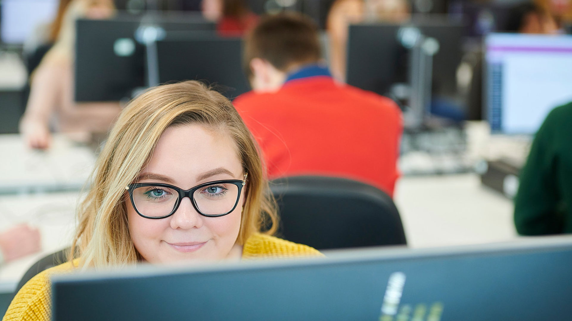 A student sits working at a computer in the Catalyst building