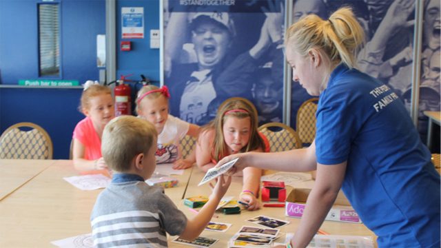 People's Family Project volunteer working with young children