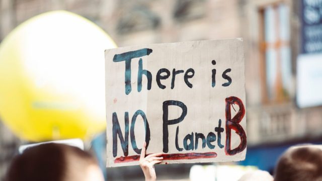 Climate change protestors hold their placards high.