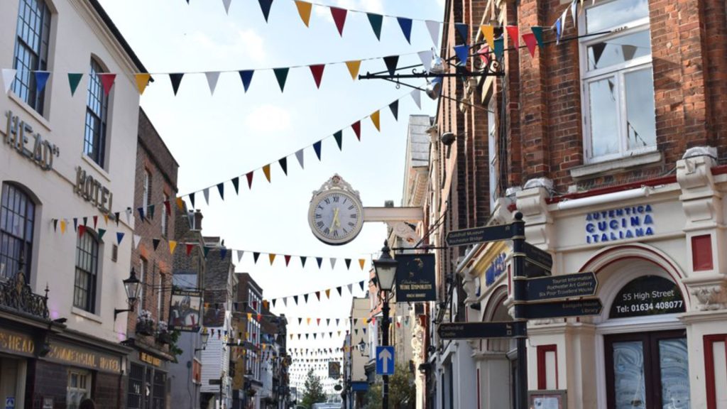 A vibrant town with lots of shops and pubs and colourful bunting