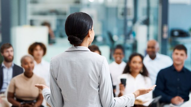 Rearview shot of an unrecognisable businesswoman giving a presentation in the office boardroom