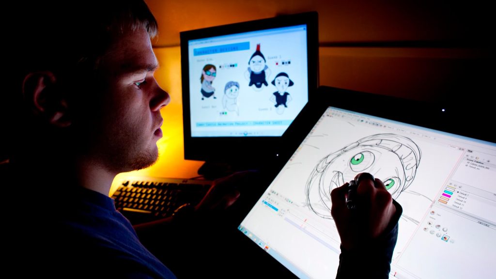A student sketches animations on a computer screen.