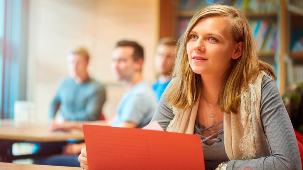 A student opens a wallet file while sat in a seminar.