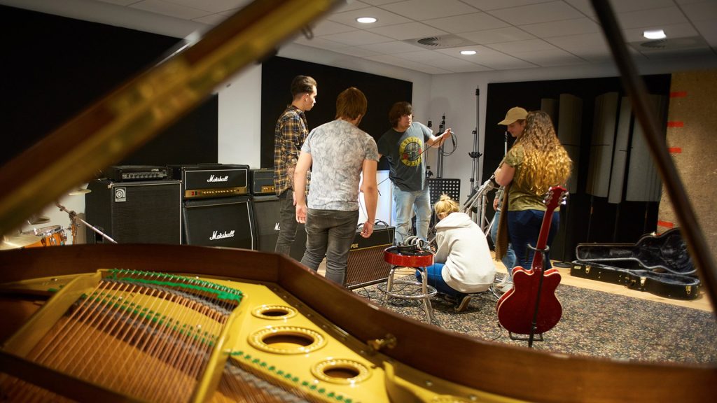 Students using recording equipment in the music studio