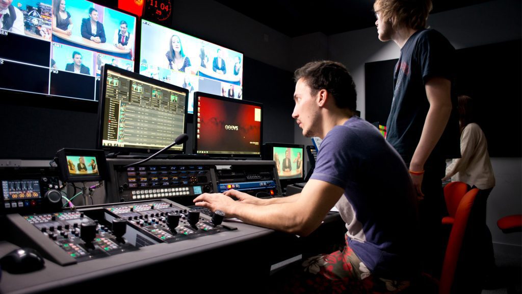 Student using a mixing desk in the recording studio