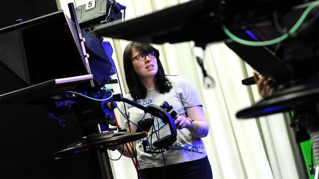 Student using a film camera in the Creative Arts department 