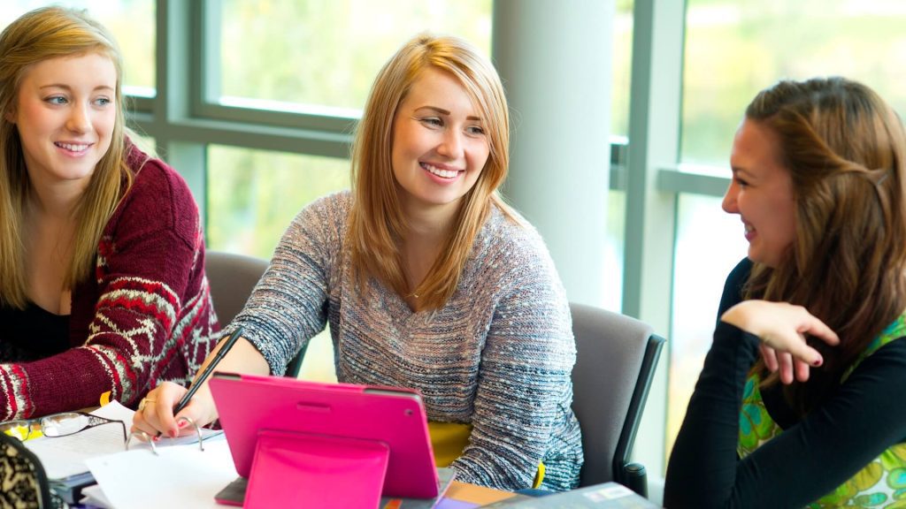 Three students in a seminar in the Faculty of Health and Social Care.