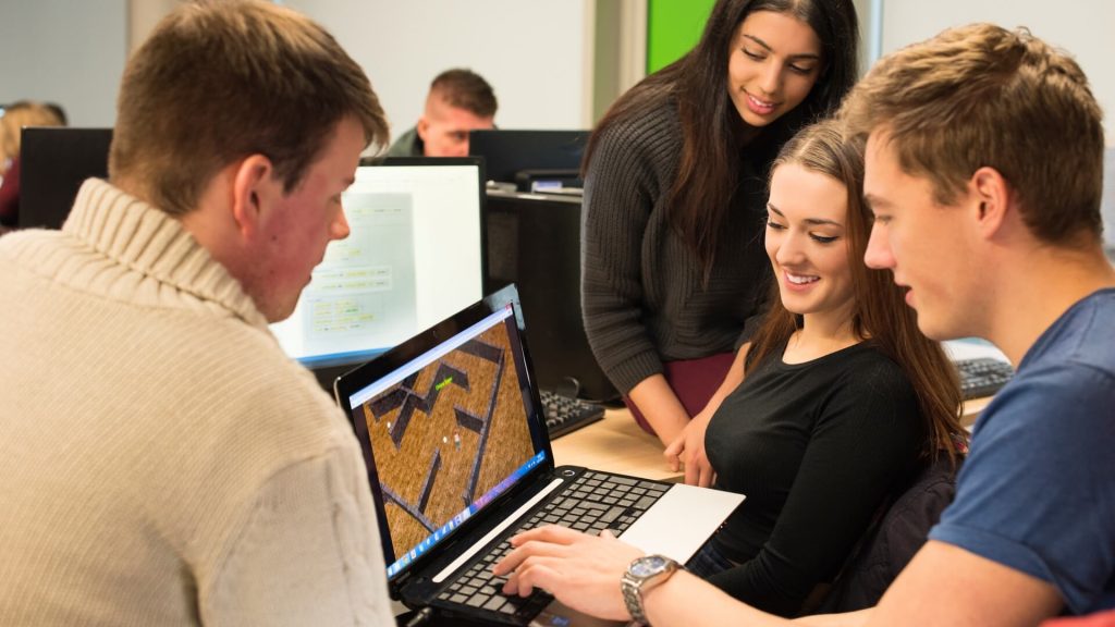 Games Programming students test a game on a laptop.