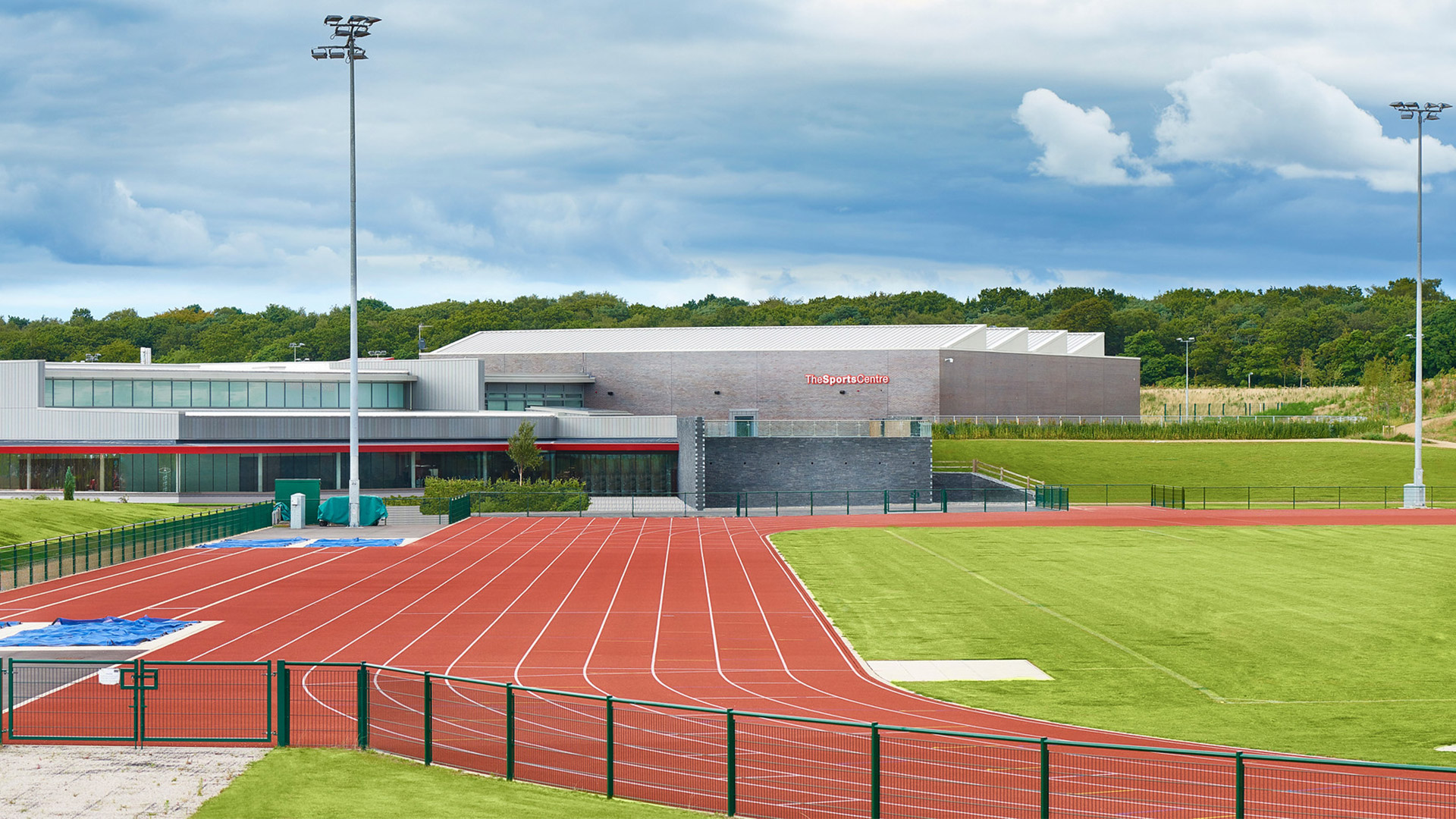 The sports centre from outside with running track and sports fields