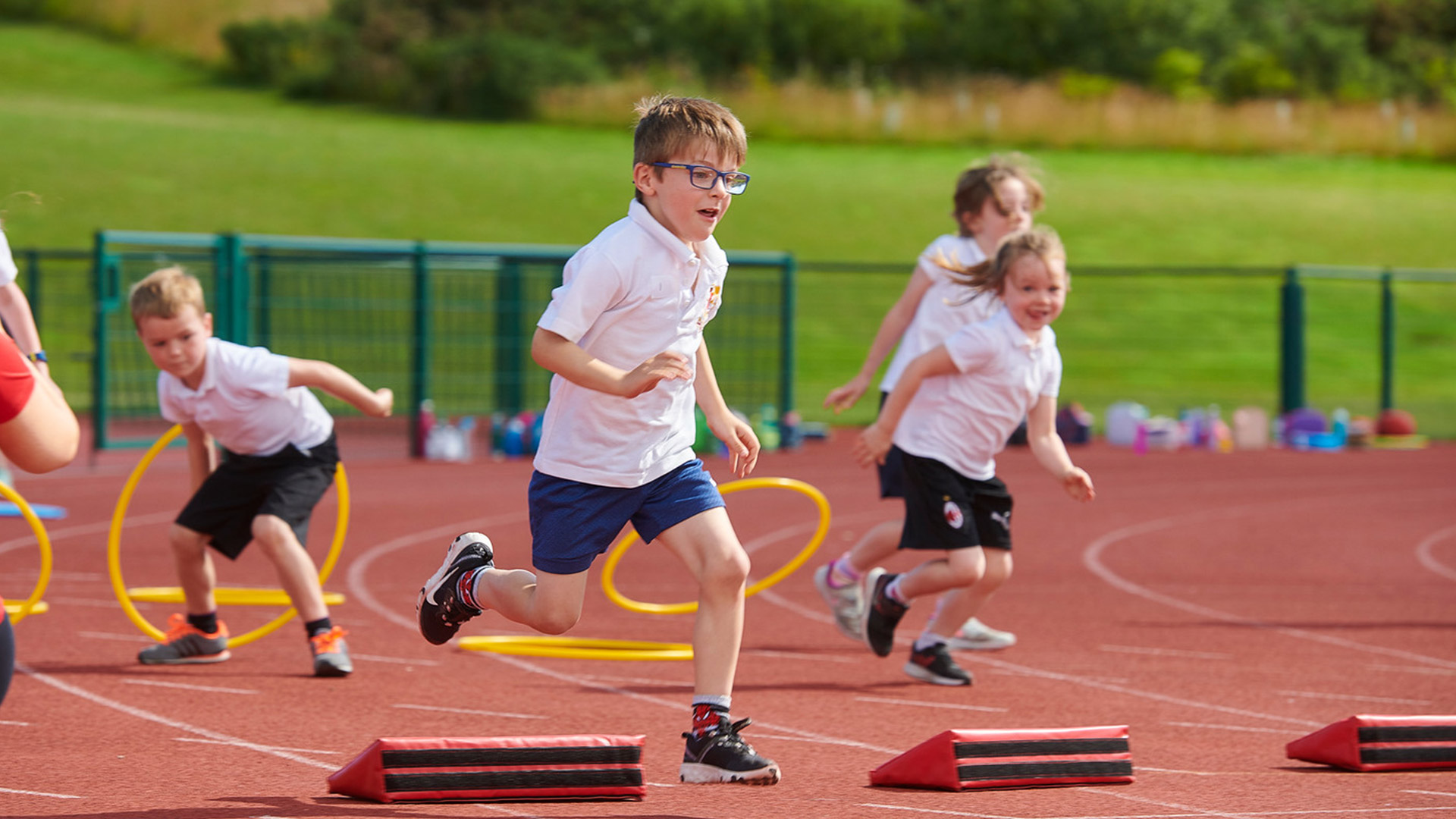 Children racing outside taking part in sports day