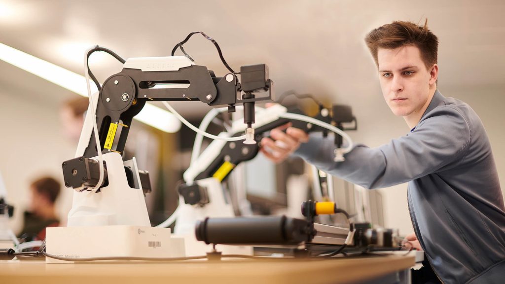 A student applies their skills in programming robots.