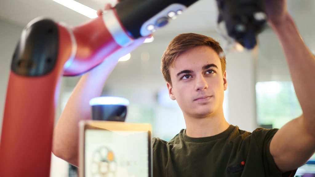 A student experiments with the Sawyer robot.