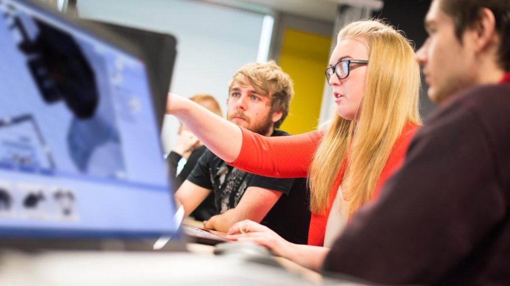 Four students sat using computers.