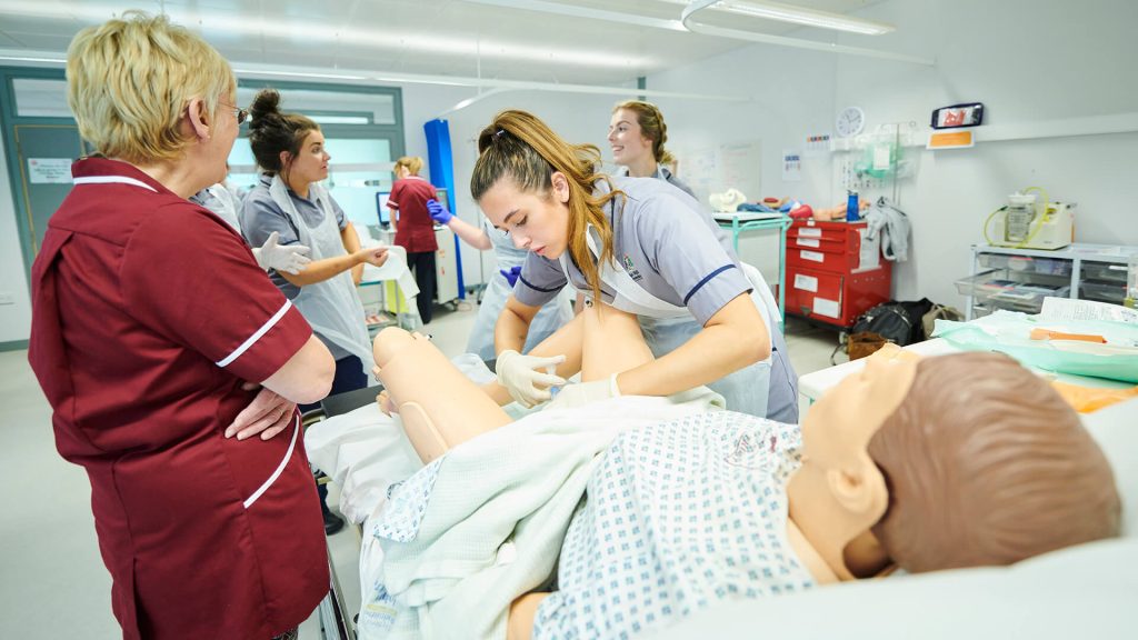 Student midwives practice their catheterisation skills.