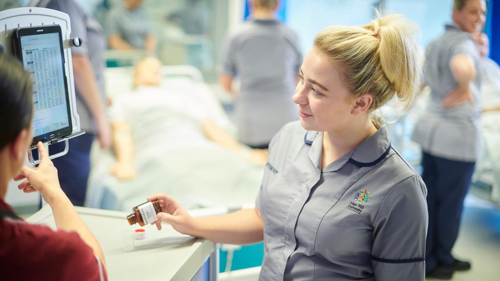 A student nurse checks a medication chart.