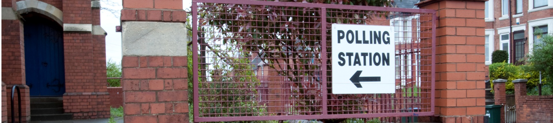 Polling station sign on building