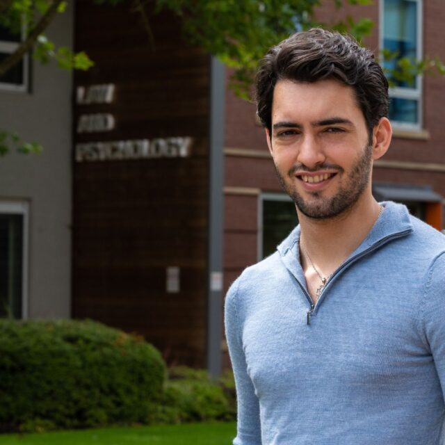 Shaun Oliver stood outside the law and psychology building