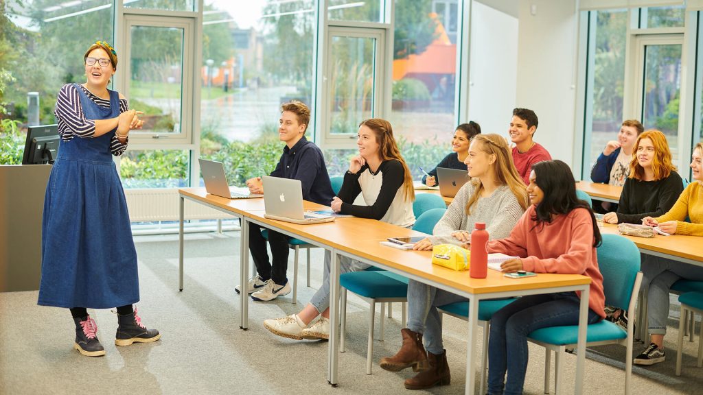 A lecturer addresses a classroom of students in the Law and Psychology building.