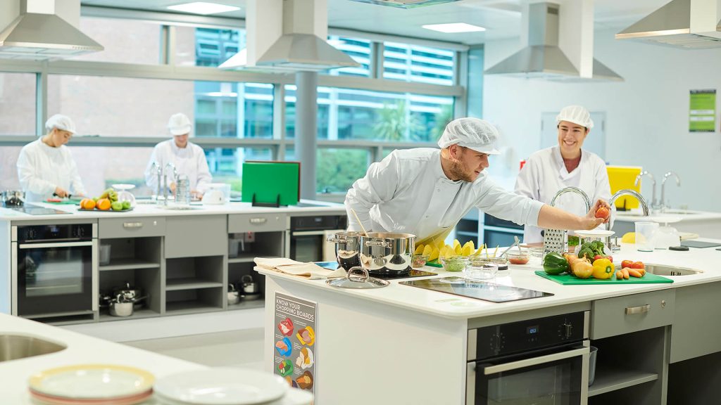 Students prepare food in the kitchen facilities in the Faculty of Health, Social Care & Medicine.