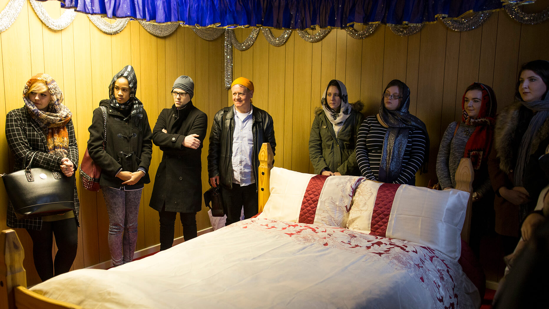 Students visit the resting place of the Guru Grath Sahib - a double bed.