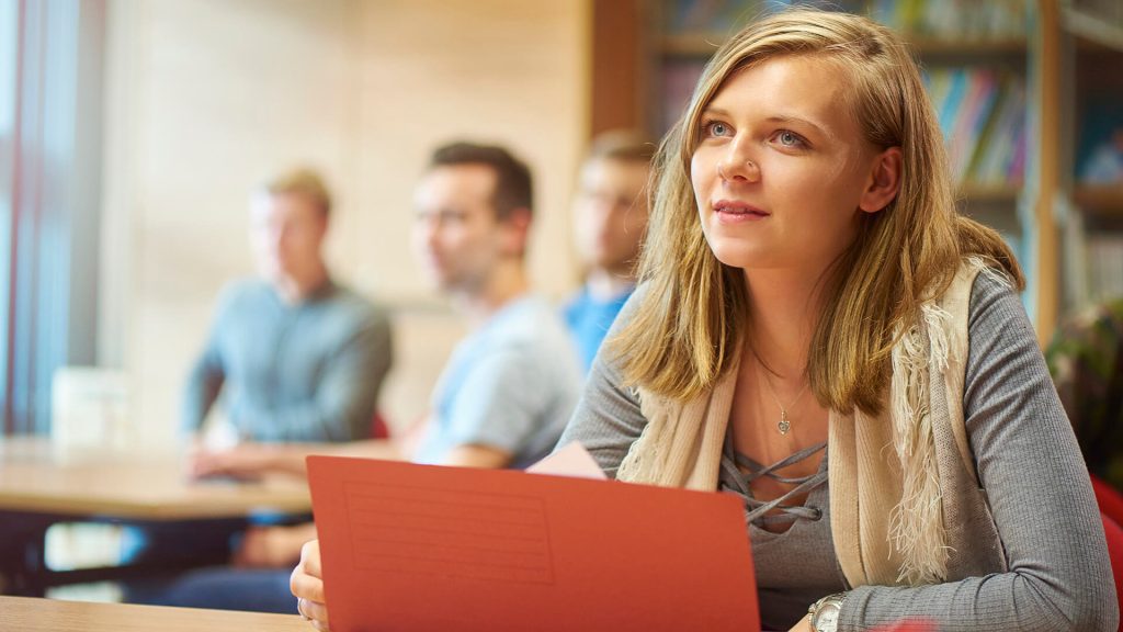 Student opens a wallet file while attending a seminar.