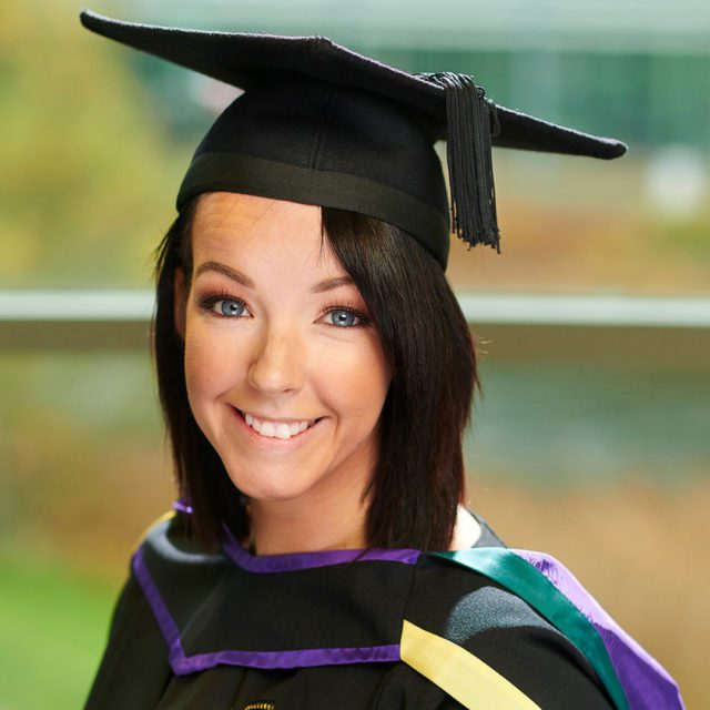 Sarah Norburn wearing a graduation and cap and gown