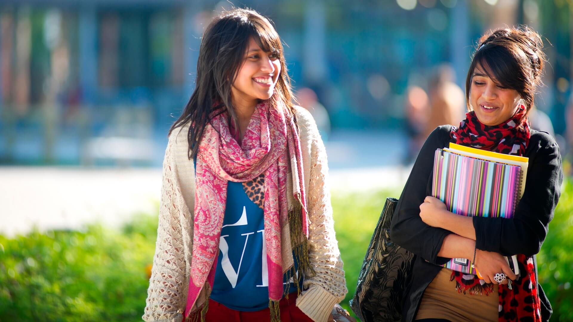 Two students walking near the Hub in the central part of campus.