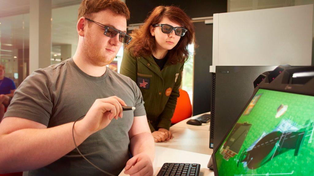 Two students work on a computer software application.