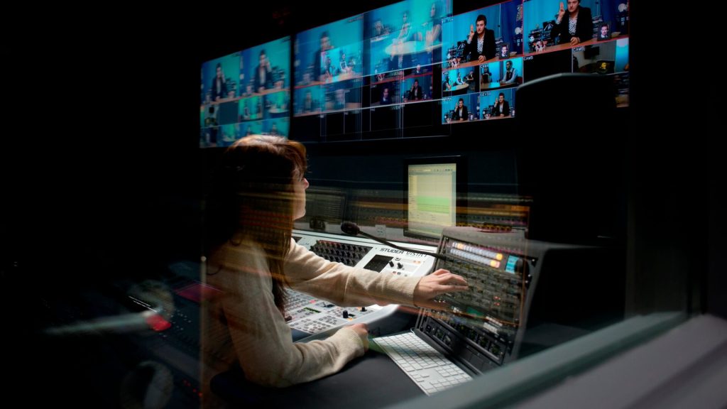A student monitors recording on the screens in the production gallery.
