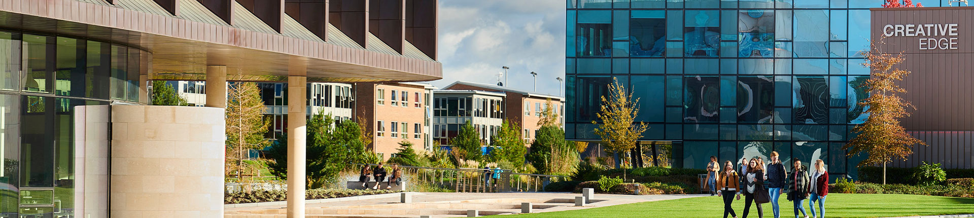 Exterior of Creative Edge and Catalyst buildings. There are students walking across the path towards the Catalyst building.