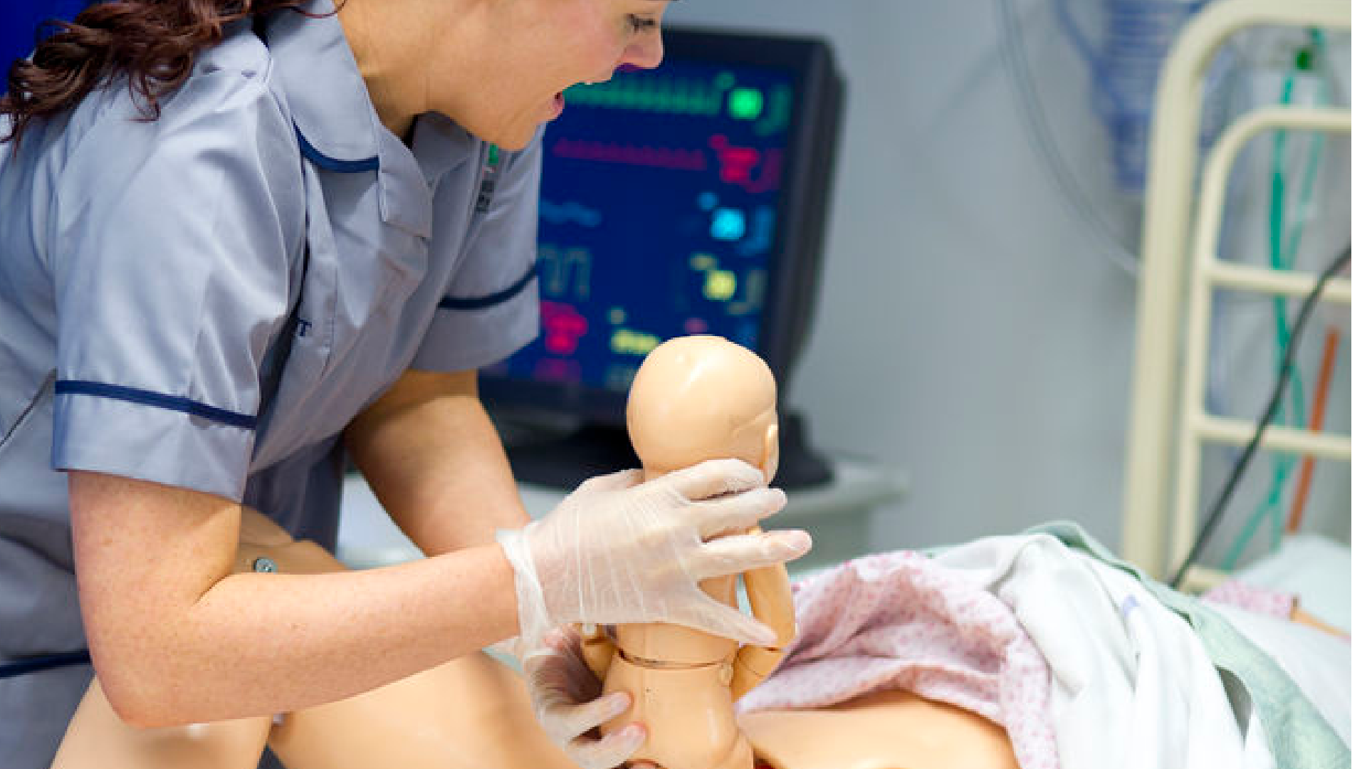 A student nurse is practicing midwifery on a practice mannequin.