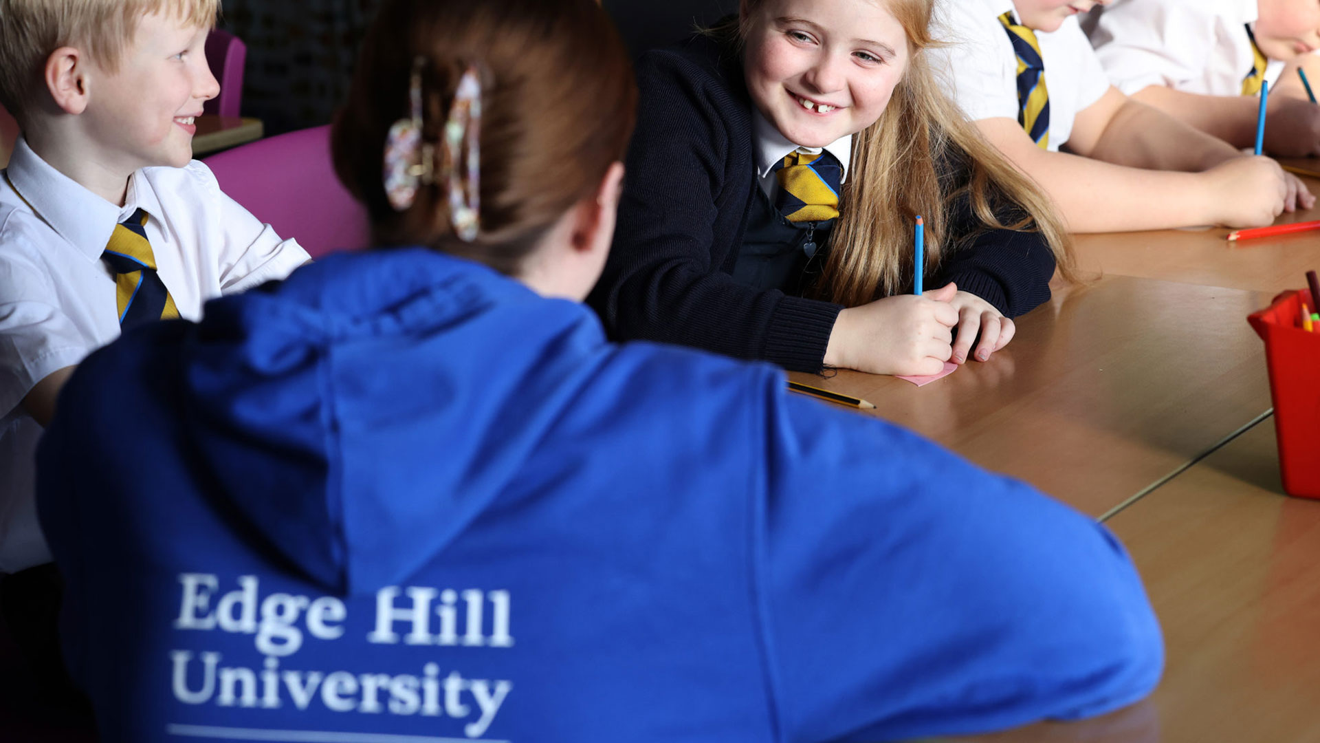 Edge-Hill-student-talking-to-primary-students