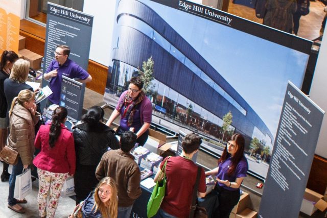Prospective students chat to Edge Hill staff at the University's stand at a UCAS exhibition.