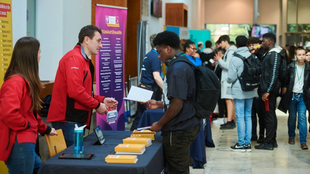 Student vising stand at Higher Education fair