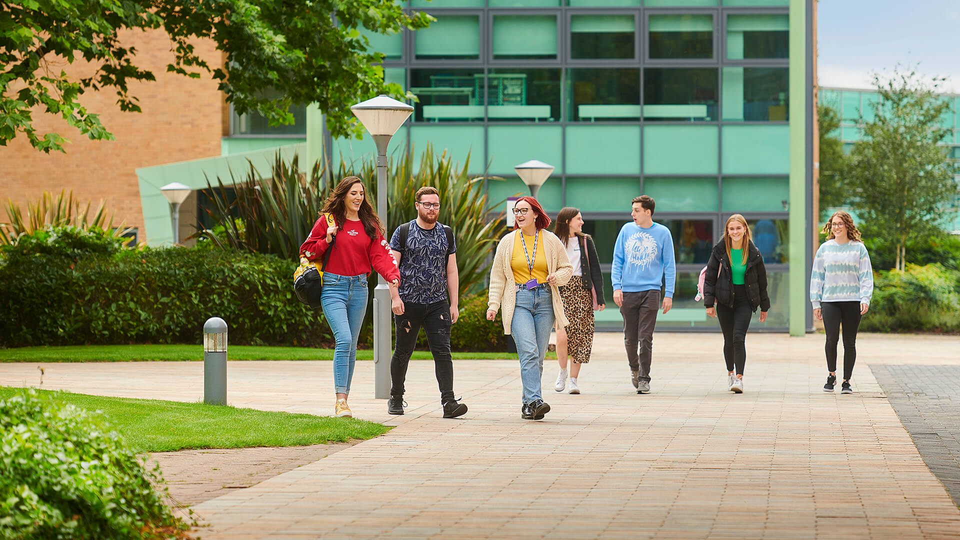 Two small groups of students walk across the piazza near the Clinical Skills and Simulation Centre.