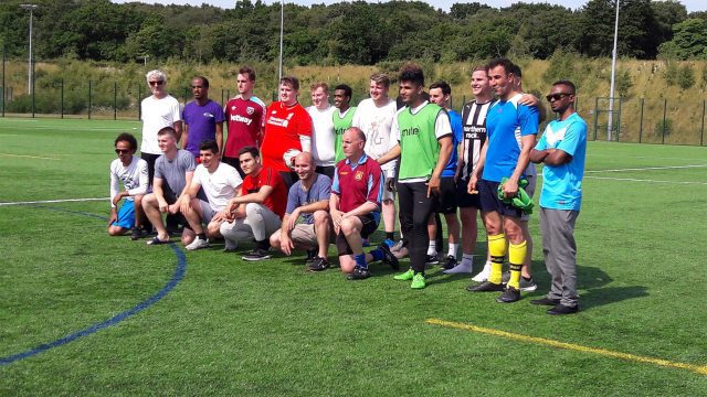 People standing together on a football pitch