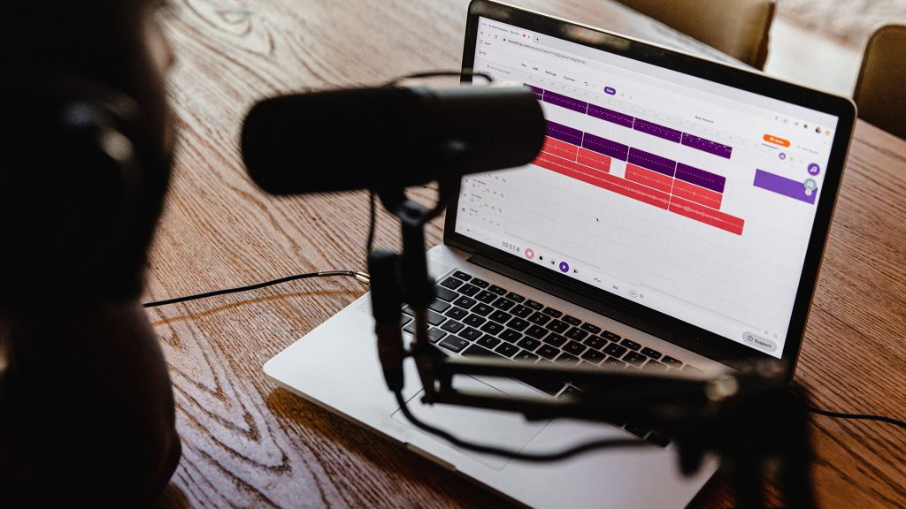 A microphone and a laptop set up for recording a podcast